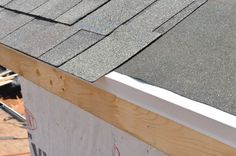 an image of a roof being built with wood shingles on the side of it