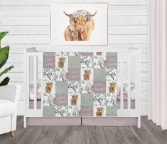 a baby crib bedding set with an animal print on the wall and wooden flooring