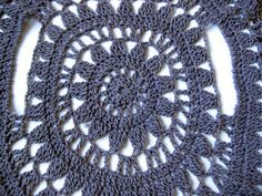 a crocheted doily is shown on a white surface