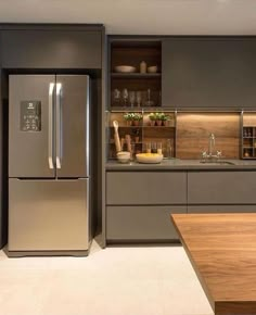 a modern kitchen with stainless steel appliances and wood cabinets