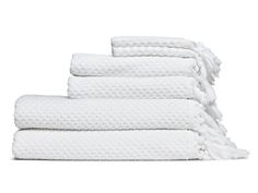 five white towels stacked on top of each other