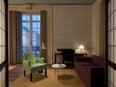 a living room filled with furniture next to a window