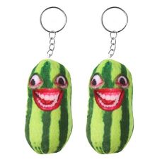 a pair of key chains with a watermelon face on it