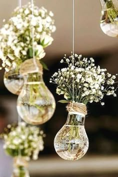 hanging glass vases filled with flowers and baby's breath