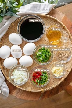 the ingredients for an egg salad are arranged on a wooden tray