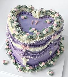 a heart shaped cake decorated with flowers and leaves