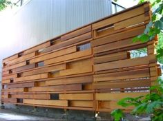 a large wooden structure sitting on the side of a road