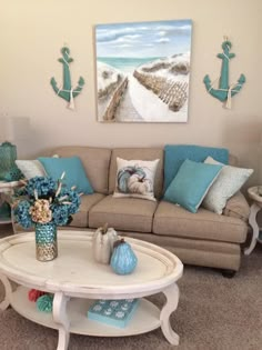 a living room filled with furniture and blue pillows on top of it's couches