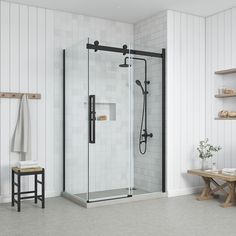 a bathroom with white walls and flooring has a walk in shower next to a wooden bench