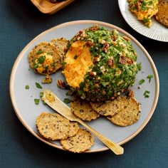 two plates with food on them and some crackers