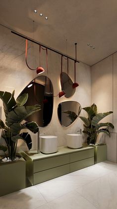 a bathroom with two sinks and mirrors on the wall next to potted plants in planters