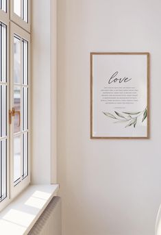 a white room with a framed poster on the wall next to a radiator