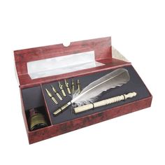 a pen, ink roller and feather quill in a wooden box