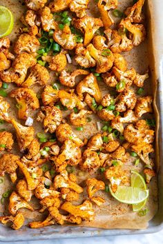 cauliflower and limes on a baking sheet