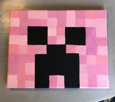 a pink and black square with squares on the bottom is painted in different shades of pink