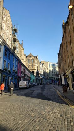 a cobblestone street lined with tall buildings