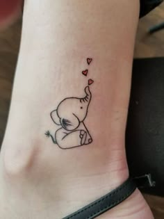 small elephant with hearts tattoo on ankle