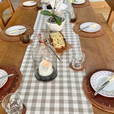 the table is set with dishes and candles