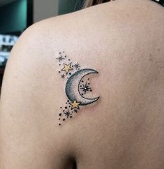 a woman's back with a tattoo on her shoulder and the moon in the sky