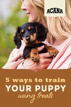 a woman holding a puppy in her arms with the caption, 5 ways to train your puppy using treats