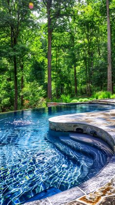 an outdoor swimming pool surrounded by trees