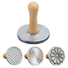 four different types of metal stampers with wooden handles