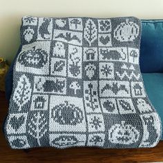 a crocheted blanket sitting on top of a blue couch