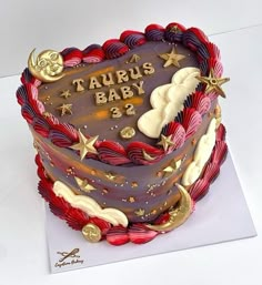 a birthday cake is decorated with stars, clouds and the words taurus baby 3