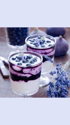 two desserts with blueberries and yogurt are on the table