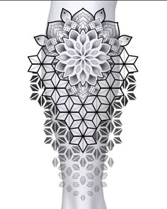 an intricate white vase with black and white designs on the bottom, in front of a white background