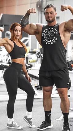 a man and woman flexing their muscles in the gym