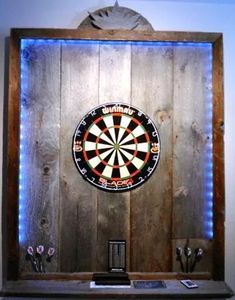 a dart board mounted to the side of a wooden wall