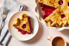 a piece of pie on a plate next to a cup of coffee and spoons