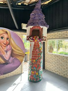 there is a fake barbie doll next to a brick tower with a purple hat on it