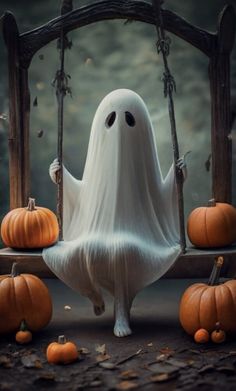 a ghost sitting on a swing surrounded by pumpkins