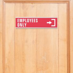 an employee only sign on a wooden door