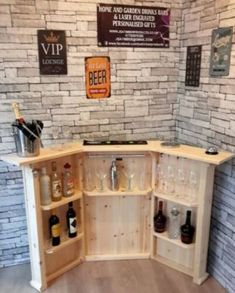 a corner bar with wine glasses and bottles on the counter in front of a brick wall