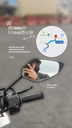 a person's hand is reflected in the side mirror of a motorbike