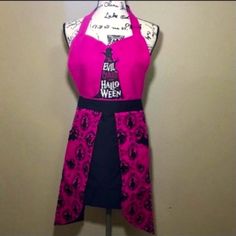 the apron is pink and black with an image of a woman's tower on it