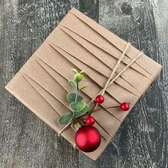 an ornament wrapped in brown paper and tied with twine on top of a wooden table