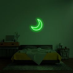 a bed in a dark room with a neon green light on the wall above it