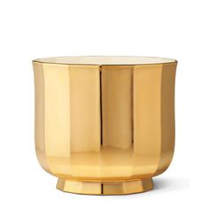 a gold vase sitting on top of a white surface