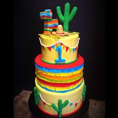 a multi layer cake with a cactus on top