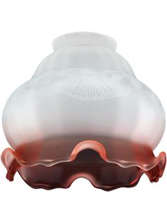 a white and red vase sitting on top of a table