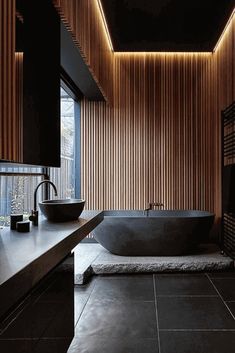 a large bath tub sitting next to a wooden wall