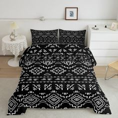 a bed with black and white patterns on it