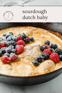 a pancake with berries and powdered sugar on top is shown in the foreground