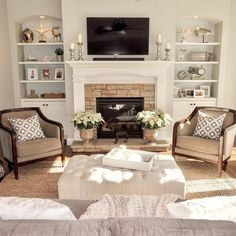 a living room filled with furniture and a flat screen tv mounted above a fire place