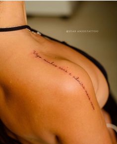 the back of a woman's shoulder with writing on it