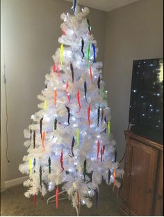 a white christmas tree decorated with colorful lights